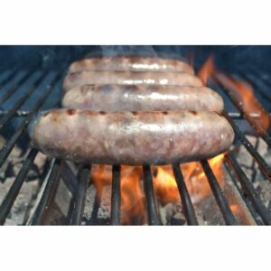 Brats sizzling on the grill, showcasing delicious grill marks and savory aromas