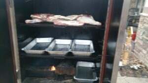 Whole pig roasting on the grill, a grand spectacle of outdoor cooking