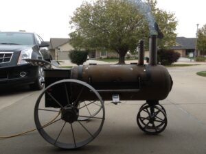 Unique custom smoker resembling a John Deere tractor, a fusion of barbecue passion and agricultural charm