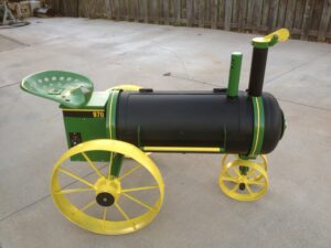 Unique custom smoker resembling a John Deere tractor, a fusion of barbecue passion and agricultural charm