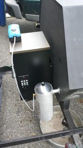 Pellet hopper attached to grill, the storage unit for wood pellets seamlessly integrated into the grilling apparatus