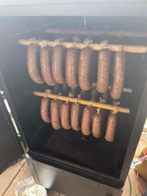 sausage hanging in the smoker – a tantalizing view of flavorful links in the midst of a smoky embrace.