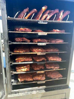Thirty-one racks of ribs beautifully aligned on a large smoker – a visual feast for barbecue enthusiasts.