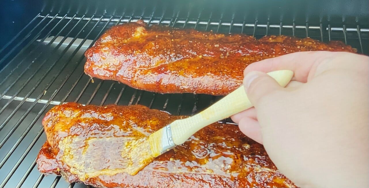 Brushing BBQ Sauce on Grilled Ribs