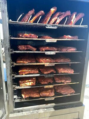 Thirty-one racks of ribs beautifully aligned on a large smoker – a visual feast for barbecue enthusiasts